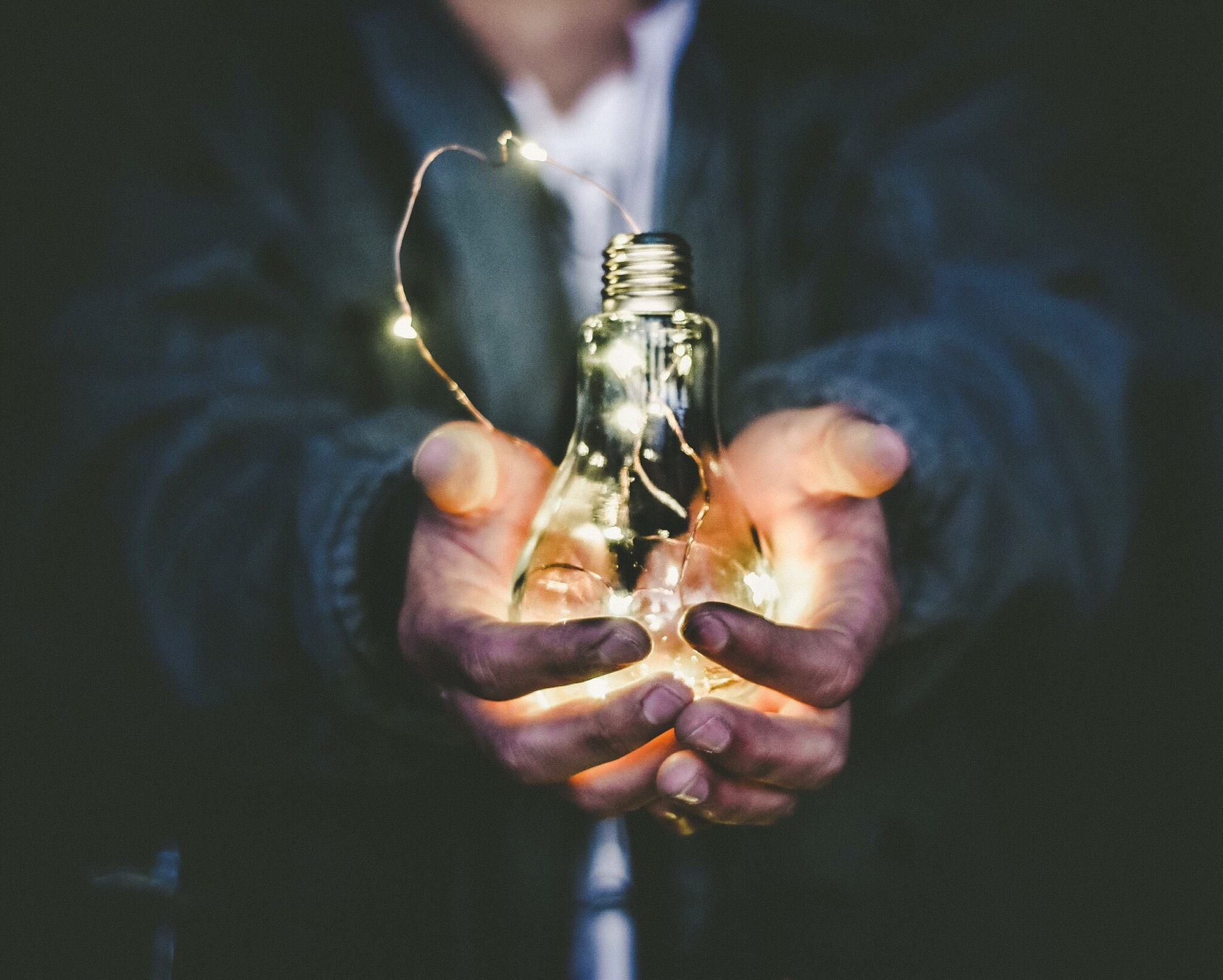 person holding lightbulb